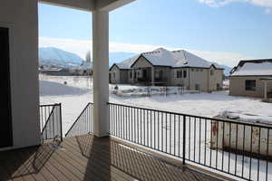 Snow covered deck with a mountain view