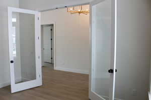 Interior space with hardwood / wood-style flooring and a notable chandelier