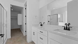 Bathroom featuring vanity and a shower with shower door