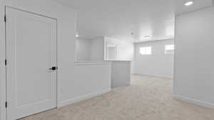 Carpeted spare room featuring a textured ceiling