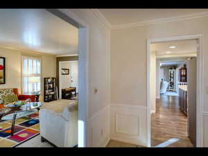 Interior space with crown molding and wood-type flooring