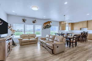 Living room featuring sink and light hardwood / wood-style flooring