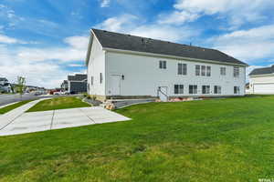 Back of property featuring a yard and a patio