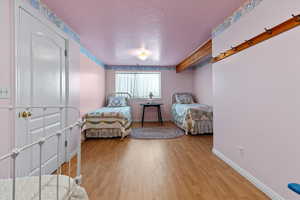 Bedroom featuring a textured ceiling and light wood-type flooring