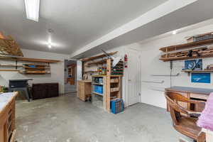 Basement featuring a textured ceiling