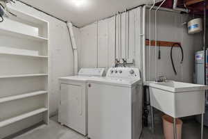 Laundry room with sink and washer and clothes dryer