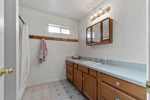 Bathroom with vanity and shower / tub combo