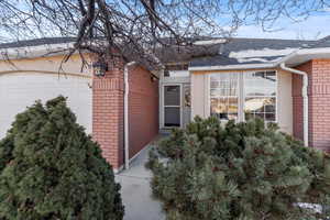 Doorway to property featuring a garage