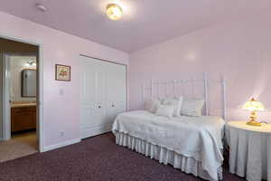 Bedroom featuring dark carpet and a closet