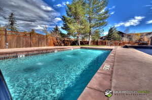 View of swimming pool with pool water feature and a patio area