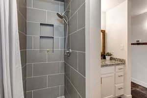 Bathroom featuring modern shower and vanity