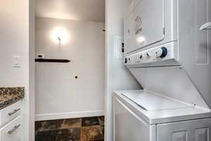 Laundry room featuring stacked washer and clothes dryer