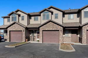 View of front of property featuring extra length garage and parking