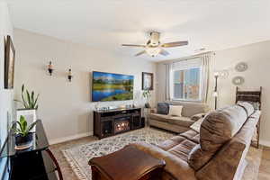 Comfortable living room space with ceiling fan.