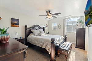 Spacious primary bedroom with walk-in closet and ceiling fan.