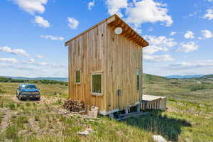 View of outbuilding featuring a mountain view and a rural view