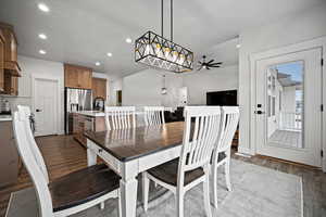 Dining area featuring dark hardwood / wood-style flooring, sink, and ceiling fan