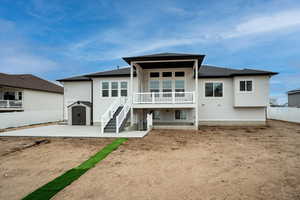 Back of property with a patio and a storage shed