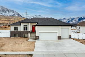 View of front facade with a mountain view and a garage