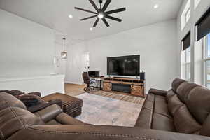 Living room featuring ceiling fan and light hardwood / wood-style floors