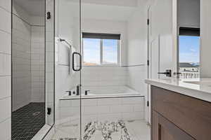 Bathroom with vanity, independent shower and bath, and tile patterned flooring