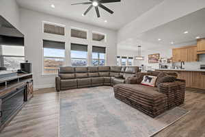 Living room featuring dark hardwood / wood-style floors, sink, and ceiling fan