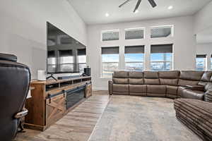 Living room featuring light hardwood / wood-style floors and ceiling fan