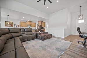 Living room featuring ceiling fan and light hardwood / wood-style floors