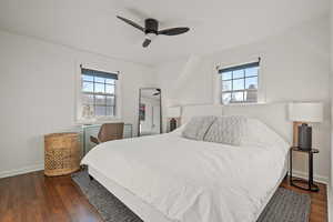 Bedroom featuring multiple windows, dark hardwood / wood-style floors, and ceiling fan