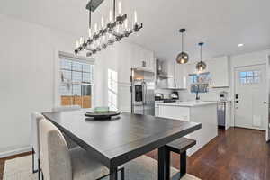 Dining room featuring plenty of natural light and dark hardwood / wood-style flooring