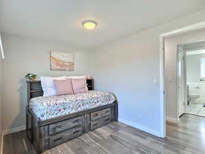 Bedroom featuring hardwood / wood-style floors and ensuite bath