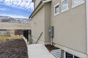 View of side of home featuring a mountain view on the way down to mother-in-law