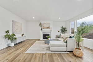 Living room with a premium fireplace and big windows for natural light and mountain views