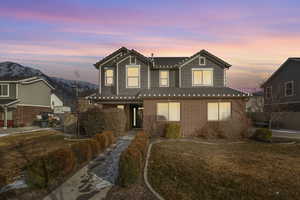 Front facade with a mountain view and a lawn