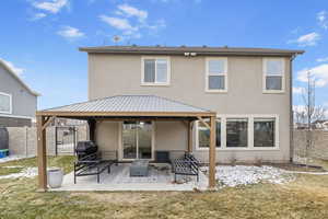 Back of house with a yard, a gazebo, and a patio