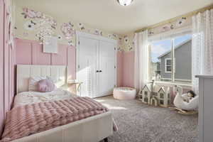 Bedroom featuring carpet floors and a closet