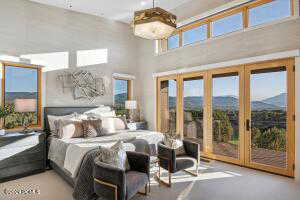 Bedroom with a mountain view and access to outside