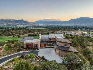 Back house at dusk featuring a mountain view