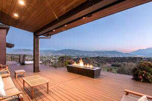 Deck at dusk with a mountain view and a fire pit