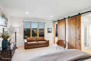 Carpeted bedroom featuring a barn door