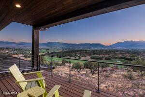 Balcony at dusk featuring a mountain view