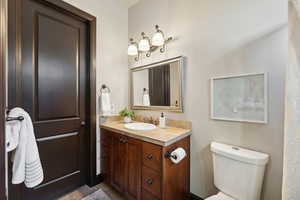 Bathroom with vanity, tile patterned floors, and toilet