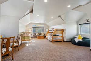 Bedroom with lofted ceiling and carpet