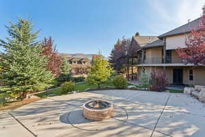 View of patio with a balcony and a fire pit