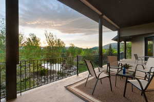 Balcony at dusk featuring a mountain view