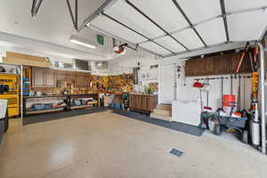 Garage with a garage door opener and a workshop area