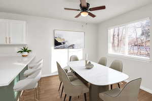 Dining space with wood-type flooring and ceiling fan