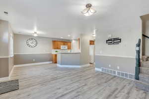 Unfurnished living room with light hardwood / wood-style floors