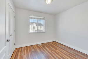 Unfurnished bedroom featuring hardwood / wood-style flooring