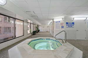 View of swimming pool featuring an indoor in ground hot tub